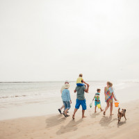 family with dog on beach